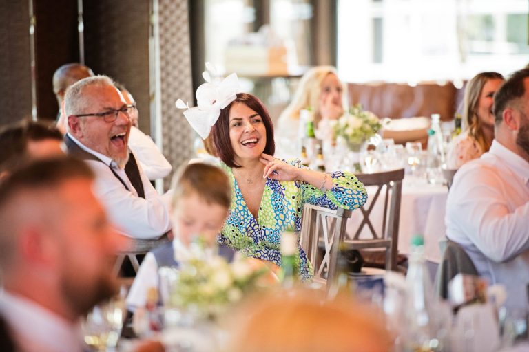 Wedding guest listening to wedding speeches.