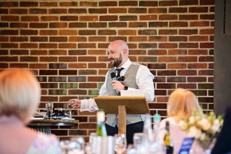 Best man listening to wedding speeches.