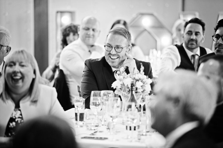 Wedding guest listening to wedding speeches. B&W image.