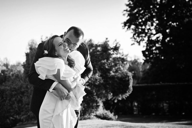 Bride and groom have a impromptu moment together. Candid. B&W image.