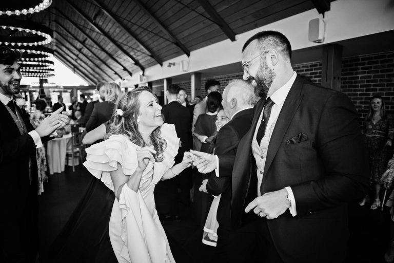 Bride and groom candidly happy. B&W image.
