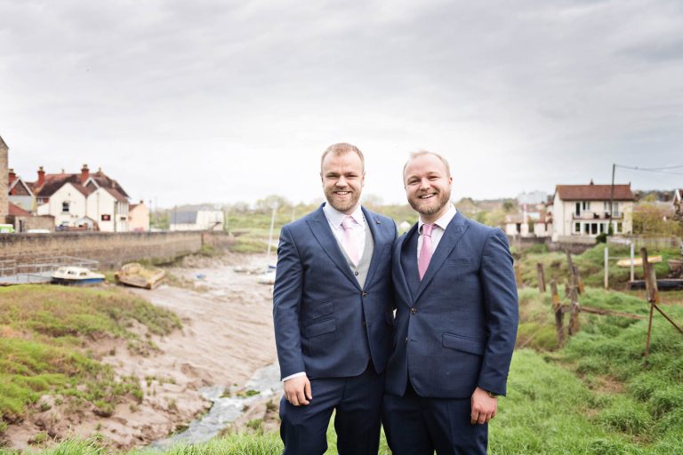 The groom (left) and his brother stand together with Pill estuary behind them. Photograph by Blooming Photography.