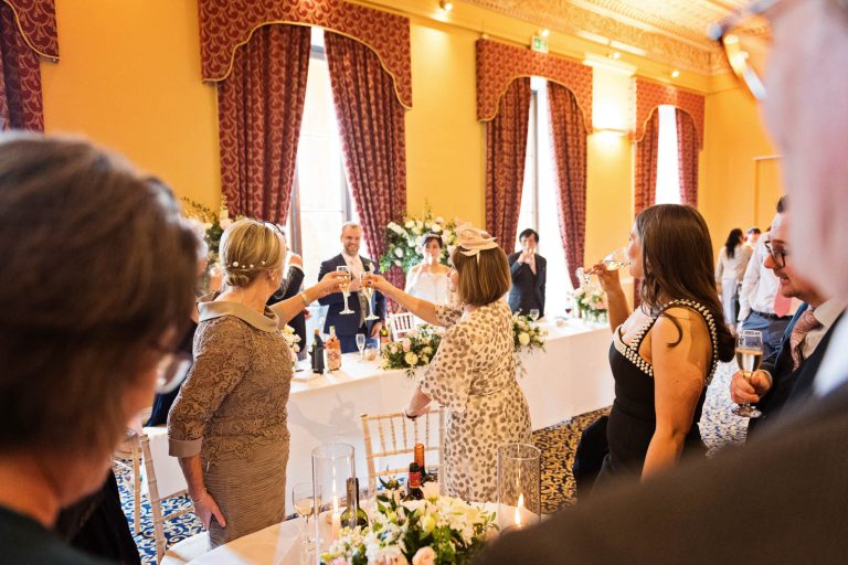Guests cheer and toast the speech. Taken in the Library at Leigh Court, candidly photographed by Blooming Photography.