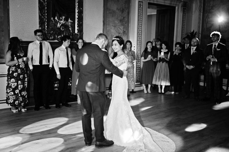 Bride and groom do their first dance in the tapestry room in Leigh Court, Bristol. Black and white photo by Blooming Photography.