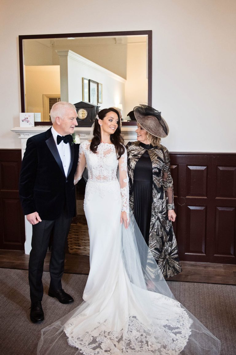 Portrait photo of the bride with her parents.