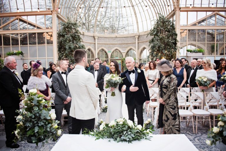 Documentary photo of bride and groom seeing each other for the first time at their wedding in the Orangery at Tortworth Court.