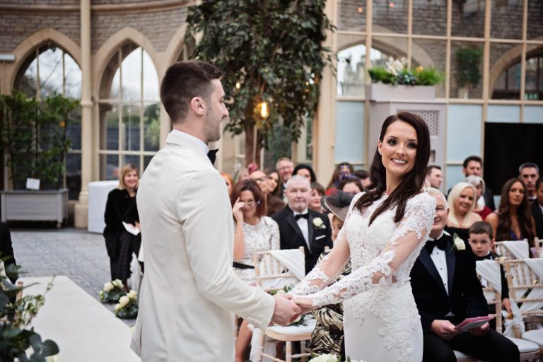 Bride and groom during their wedding ceremony in the Orangery at Tortworth Court.