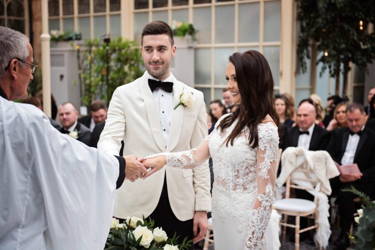 Bride and groom during their wedding ceremony (being blessed by a vicar)