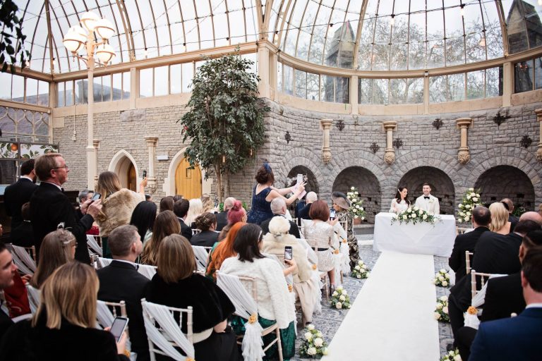 Bride and groom sign the register after their wedding in The Orangery at Tortworth Court