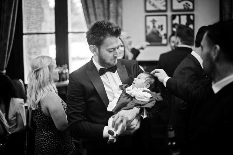 Candid photo of very small baby during wedding reception at Tortworth Court.