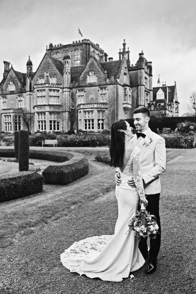 Portrait photo of bride and groom in the grounds of Tortworth Court at their winter wedding.
