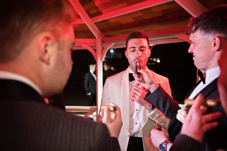 Grooms lighting a cigar