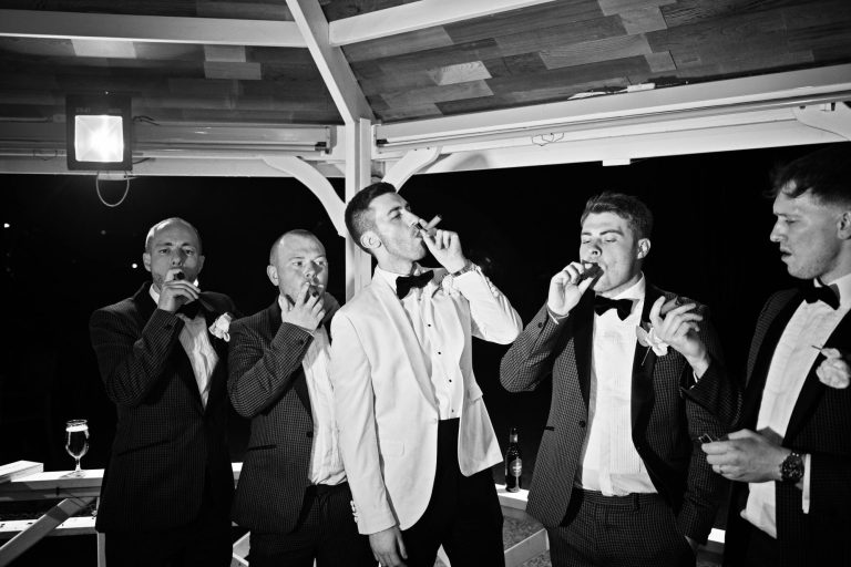 B&W image of Groomsmen smoking cigars