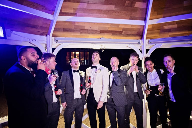 Groomsmen smoking cigars