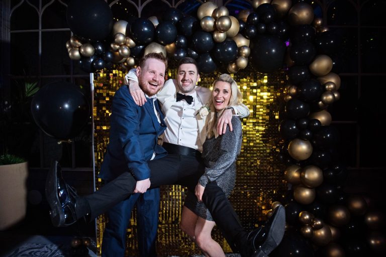 Candid photo of groom having fun with wedding guests.