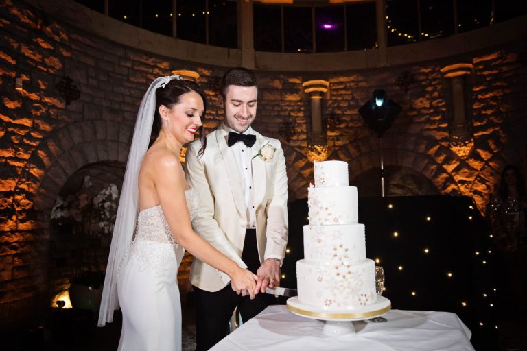 Bride and groom cut their wedding cake.