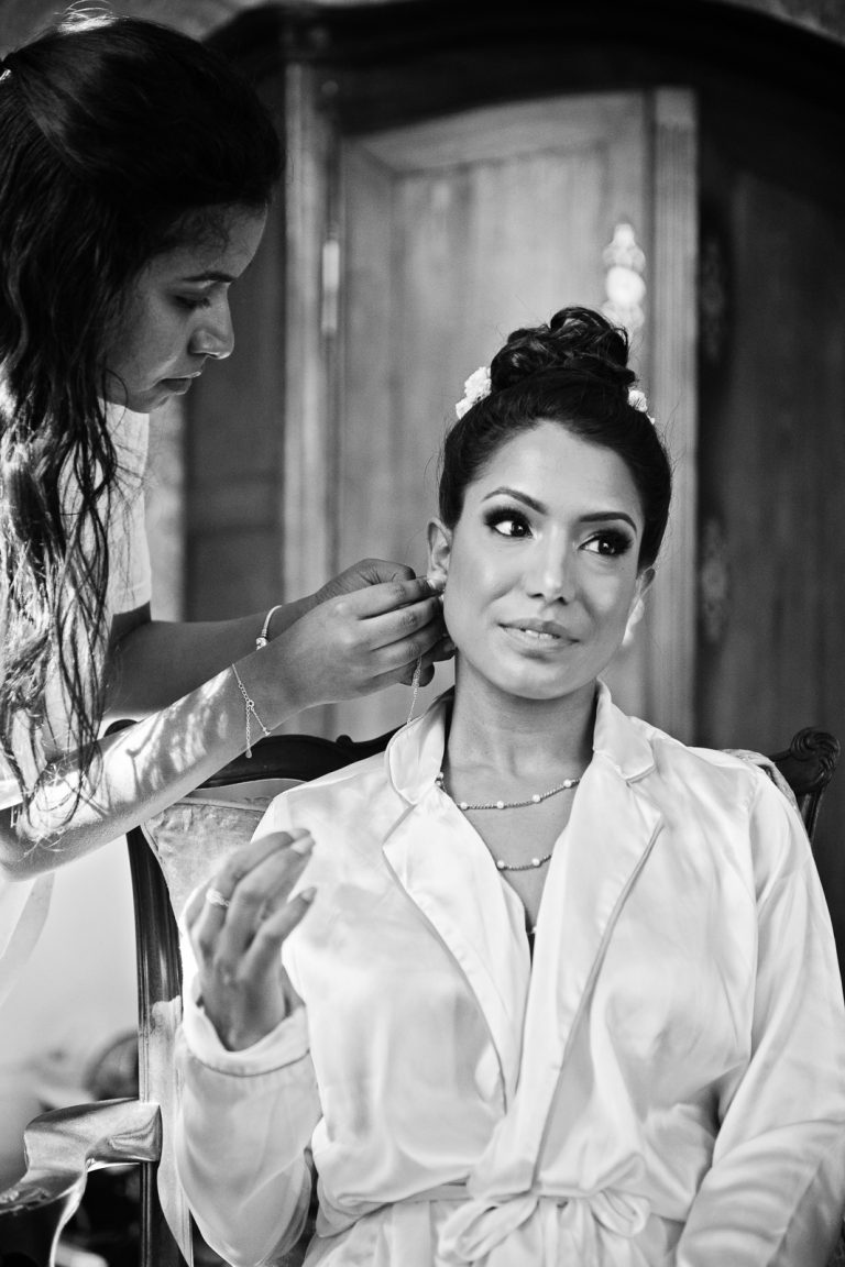 Bride's having her earrings put in at North Mymms Park, by Blooming Photography