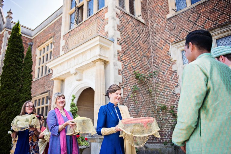 Mother of the groom and her helpers bring gifts to the groom at North Mymms Park, candidly photographed by Blooming Photography.