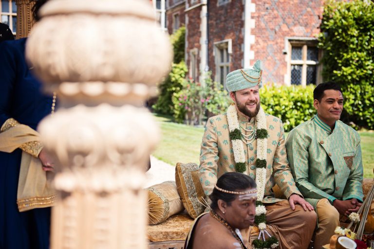 Groom awaits for his bride at North Mymms Park, candidly photographed by Blooming Photography. Colourful.