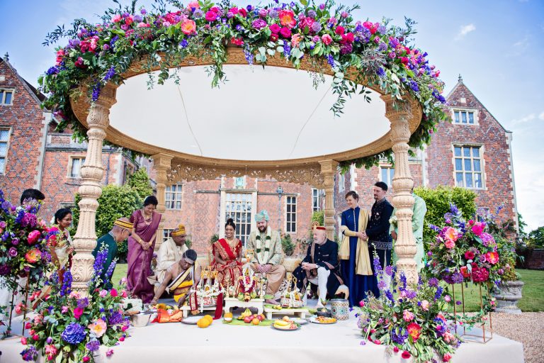 Hindu outdoor ceremony at North Mymms Park, candidly photographed by Blooming Photography. Colourful & floral.