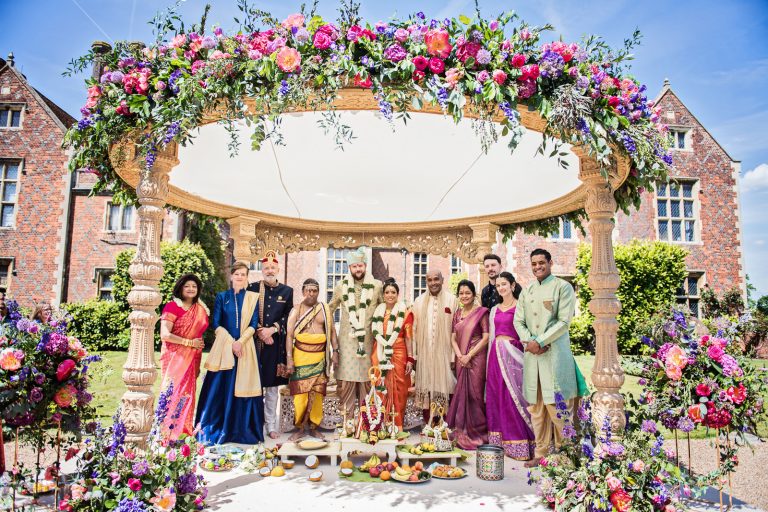 Family line up after the Hindu ceremony at North Mymms Park, candidly photographed by Blooming Photography.
