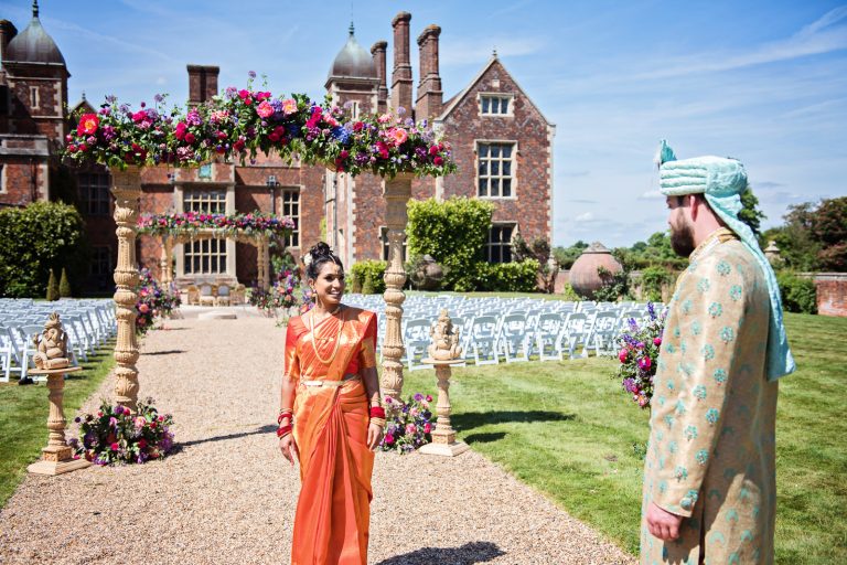 Bride & Groom look at each other after Hindu ceremony at North Mymms Park, candidly photographed by Blooming Photography.