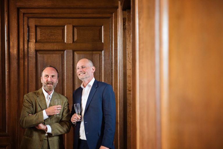 Candid photo of guests chatting together at North Mymms Park, candidly photographed by Blooming Photography.