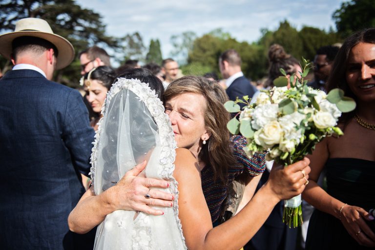 Bride hugs her new mother in law. Candid, documentary wedding. Photographed at North Mymms Park, by Blooming Photography.