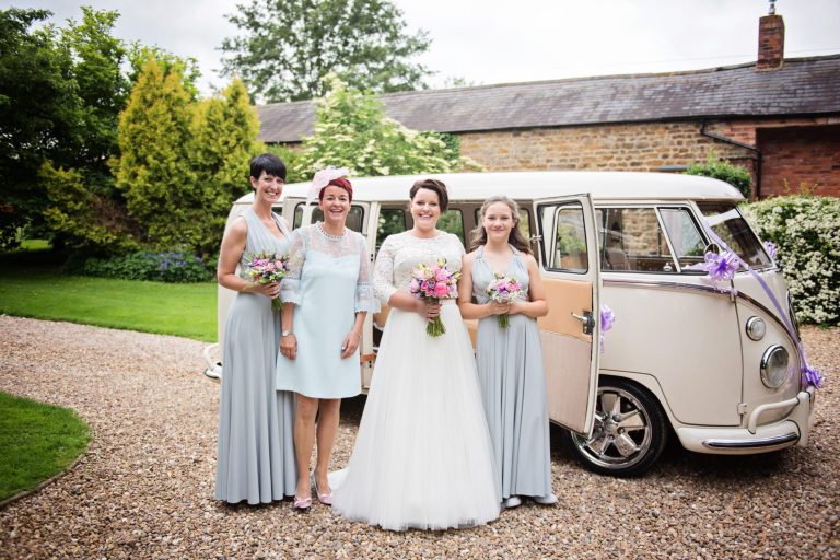 Formal ish photo of bridal party standing in front of VW split screen campervan.