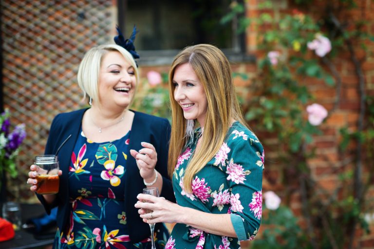 Candid photograph of guests smiling and laughing.