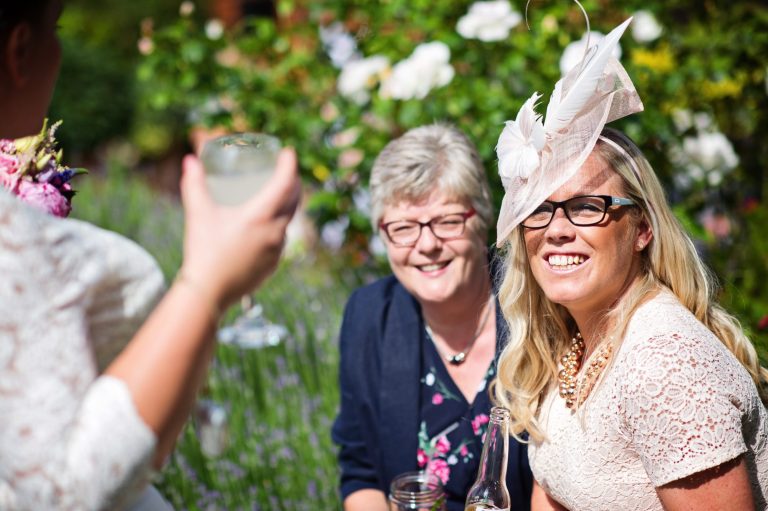Candid photograph of wedding guests chatting