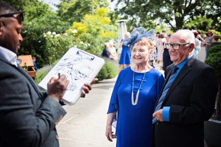 Caricaturist drawing during a wedding of an older couple.