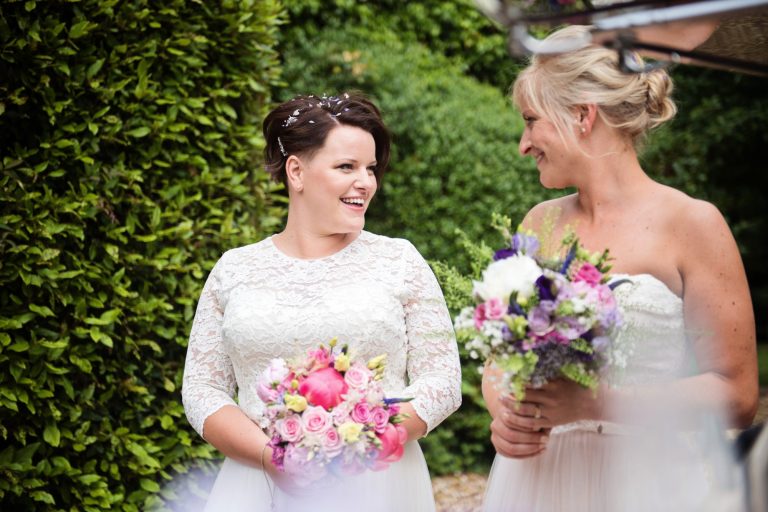 Informal photo of bride and bride chatting.