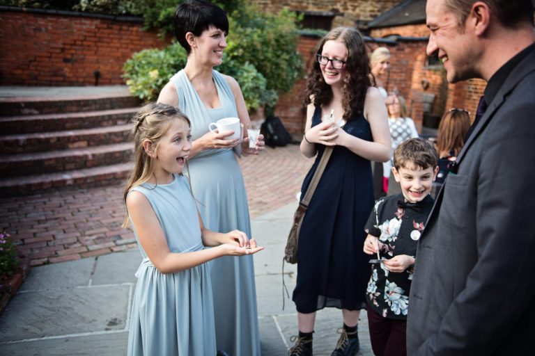 Flower girl gets wowed by the magician's magic trick