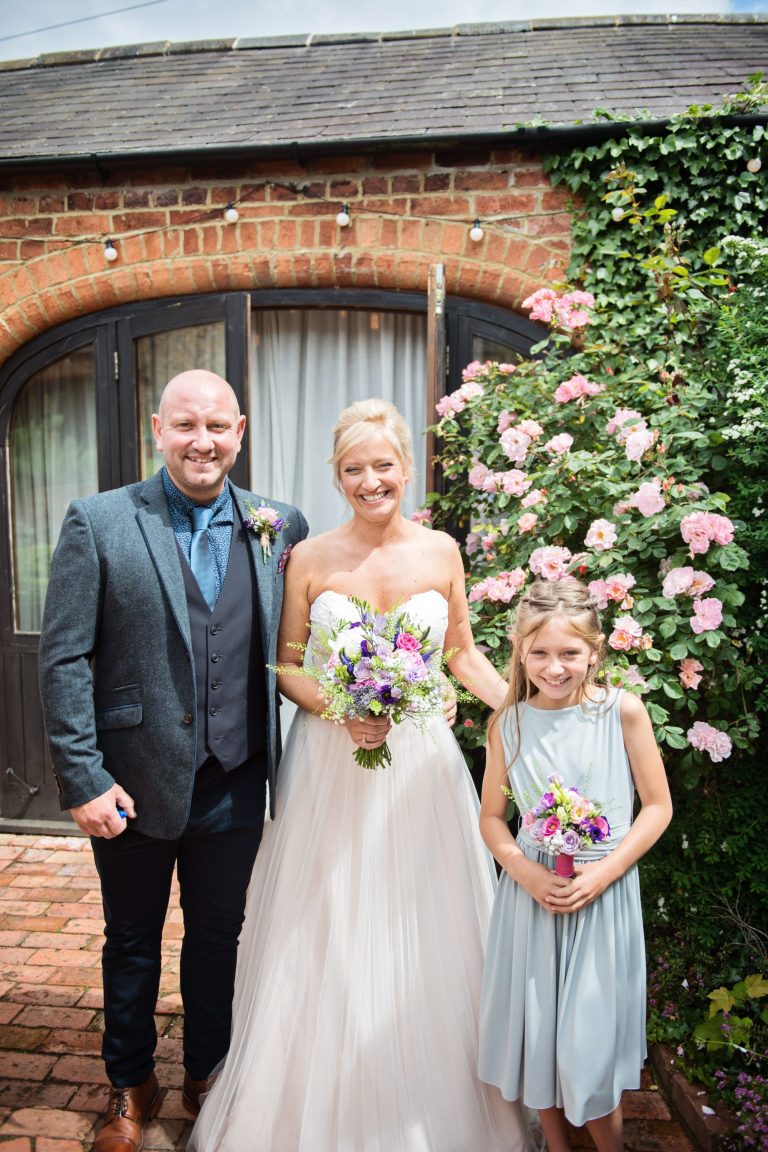 Portrait photo of bride and her brother and flower girl.