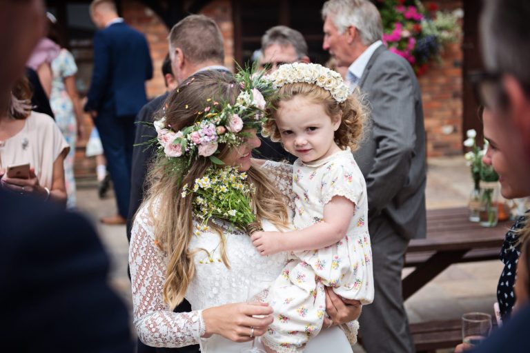 Candid wedding photo of bride and her daughter at Gloucestershire wedding venue Over Barn, Gloucester.