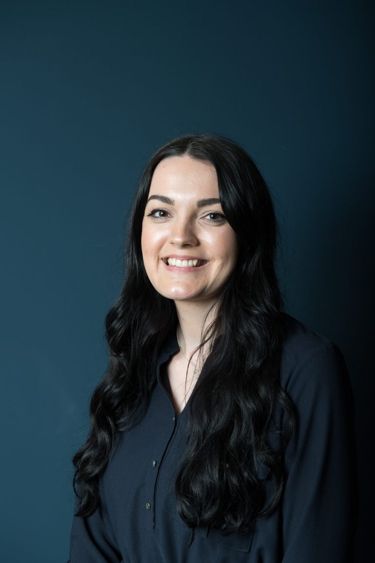 LinkedIn profile headshot with blue background