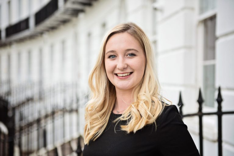 Staff headshot standing outside.a office building.