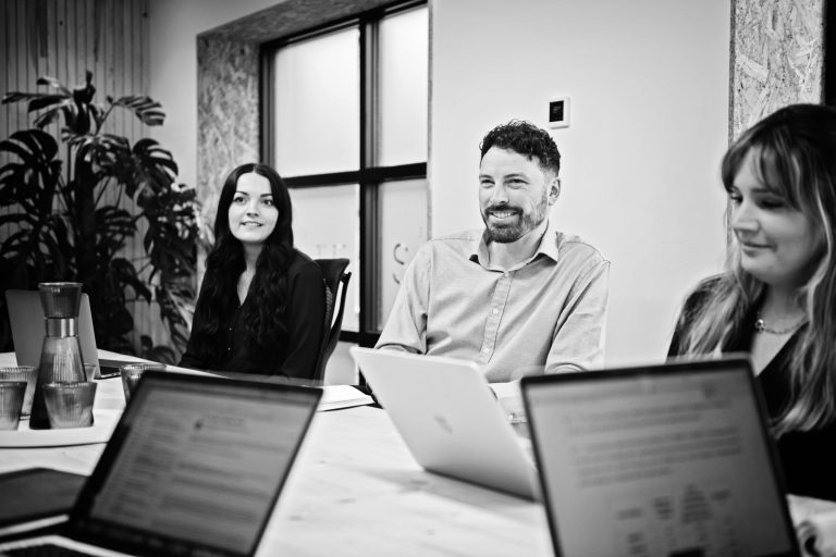 Staff in a boardroom meeting (B&W images).