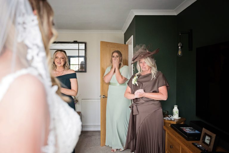 bridesmaids crying in emotion after seeing the bride for the first time.