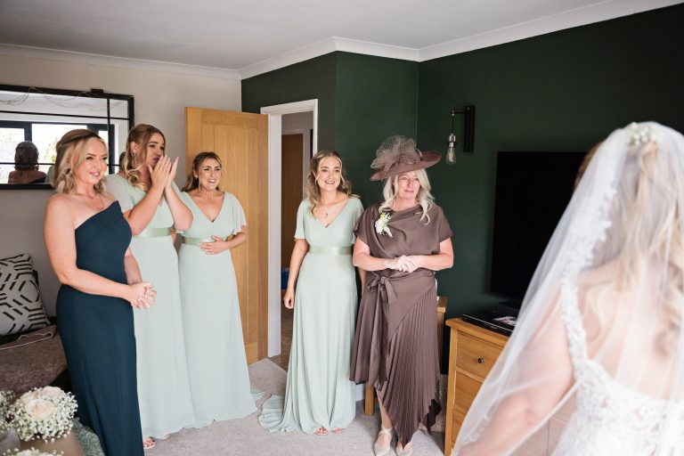 bridesmaids crying in emotion after seeing the bride for the first time.