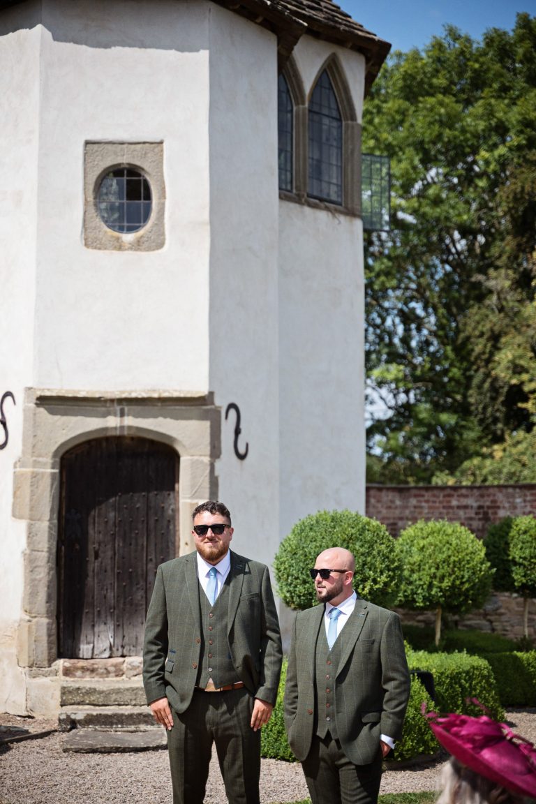 Groom and bestman stand in front of a folly/castle and wait anxiously for the brides arrival.