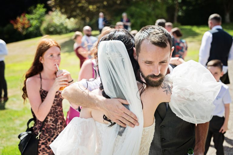 A wedding guest hugging the bride