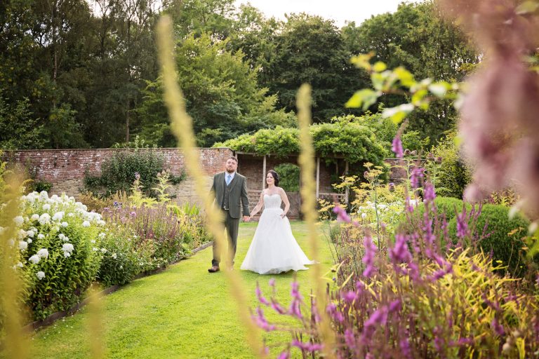 Natural wedding photographer in the gardens of Bride and groom in Herefordshire wedding venue, Homme House.