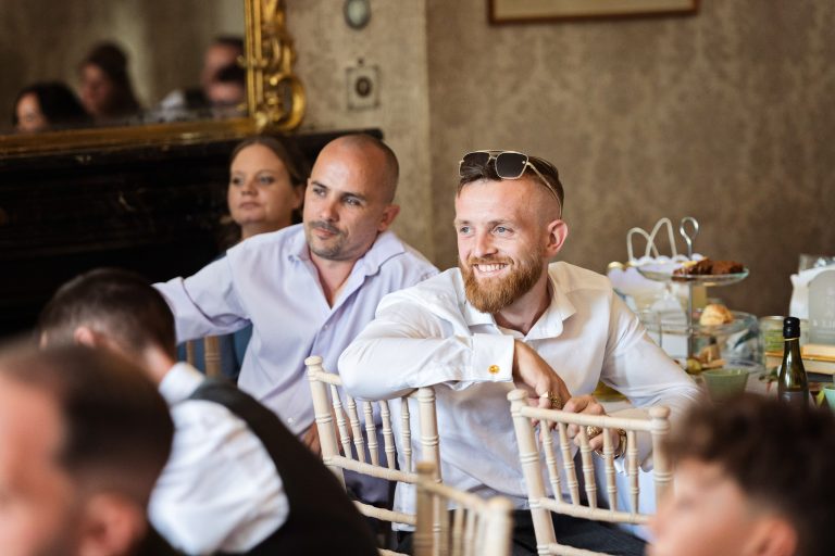 Candid wedding photo of guests enjoying the wedding speech at Homme House