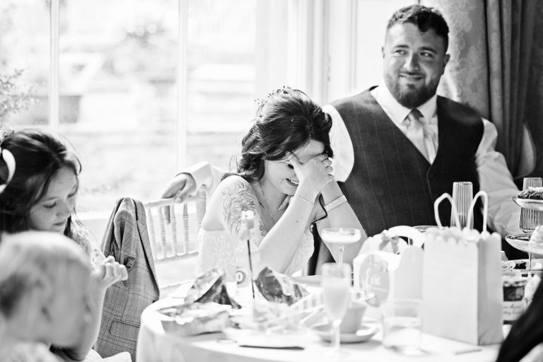 Candid wedding photograph taken at Homme House of a bride during the speeches