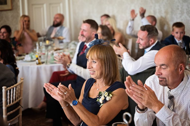 Wedding guests clap at the end of the speeches at Homme House