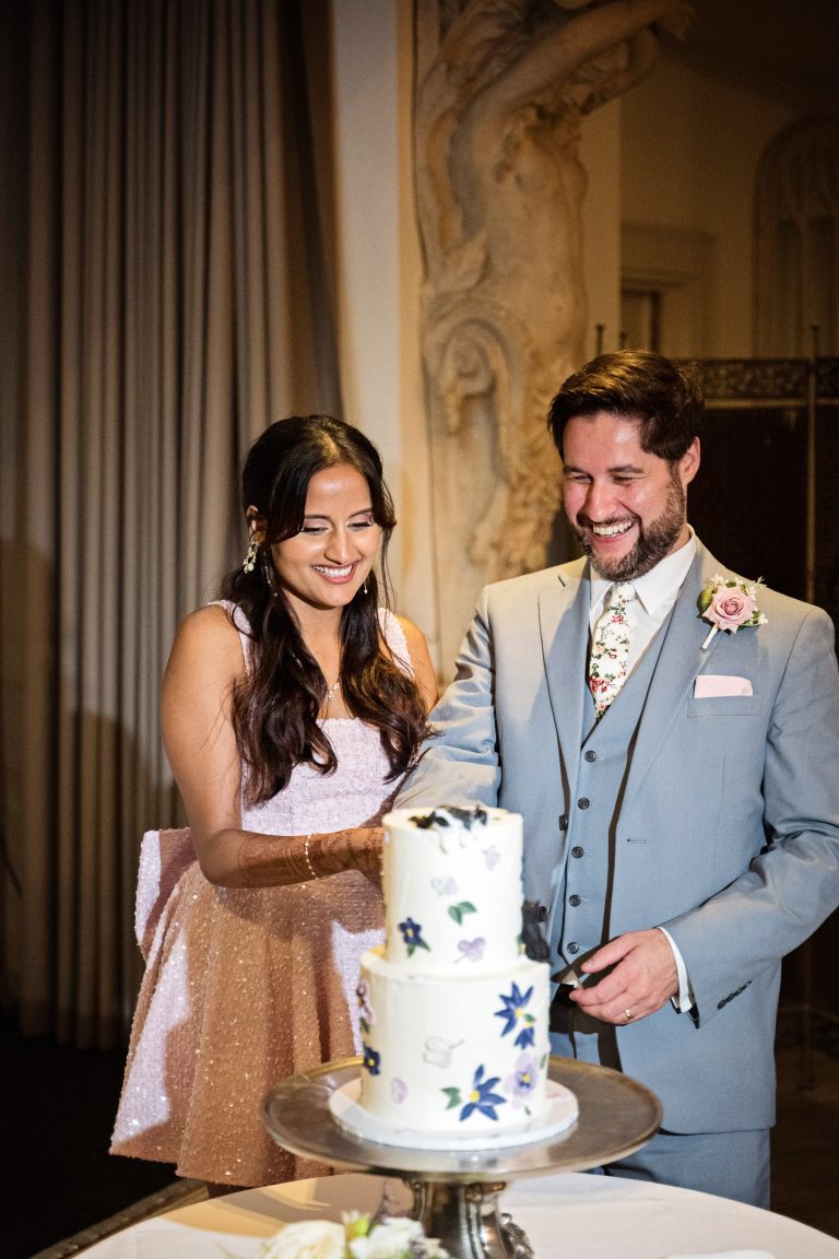 Cutting of the cake at Manor By The Lake by Blooming Photography