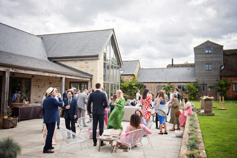 Exterior photograph of the grounds at Blackwell Grange with wedding guests chatting