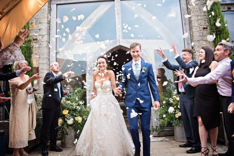 Bride and groom get showered with confetti at Cripps Barn.